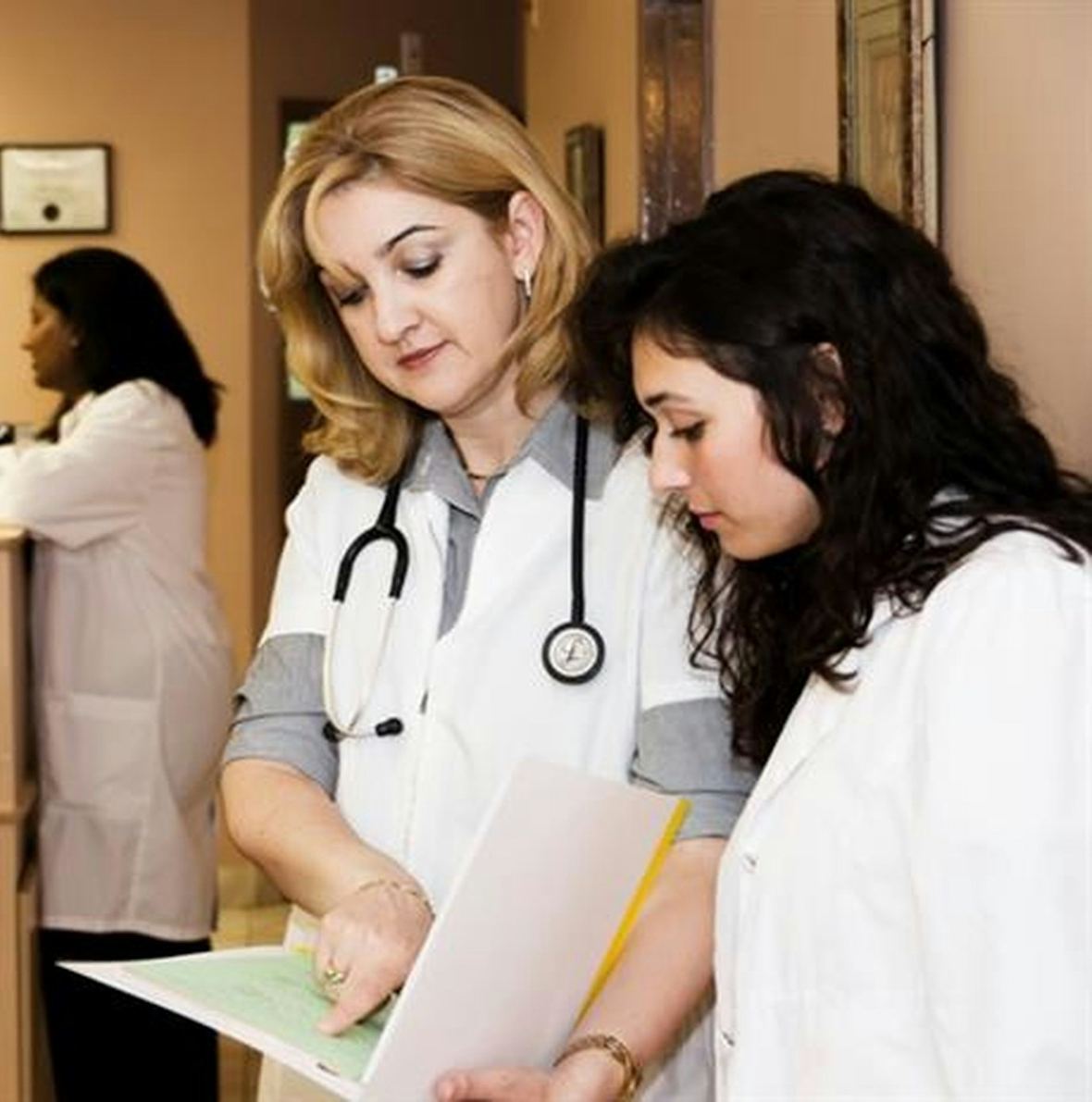 Hospital staff reviewing paperwork at the reception desk