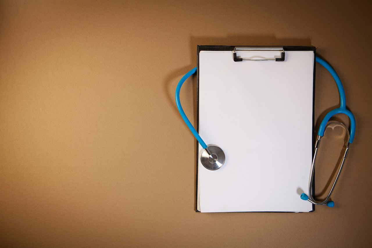 Clipboard and stethoscope on a desk